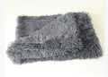 Long plush dark grey pet blanket shown as a dog bed and a reversible floor cushion.