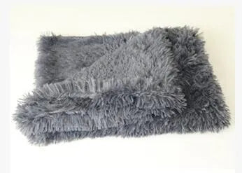 Long plush dark grey pet blanket shown as a dog bed and a reversible floor cushion.