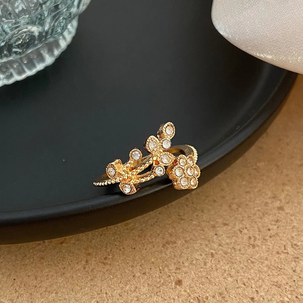 Women's open ring with diamond treatment flower leaves design in gold or white colour