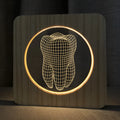 Wood colour tooth-shaped acrylic night light on a surface with a USB cable.