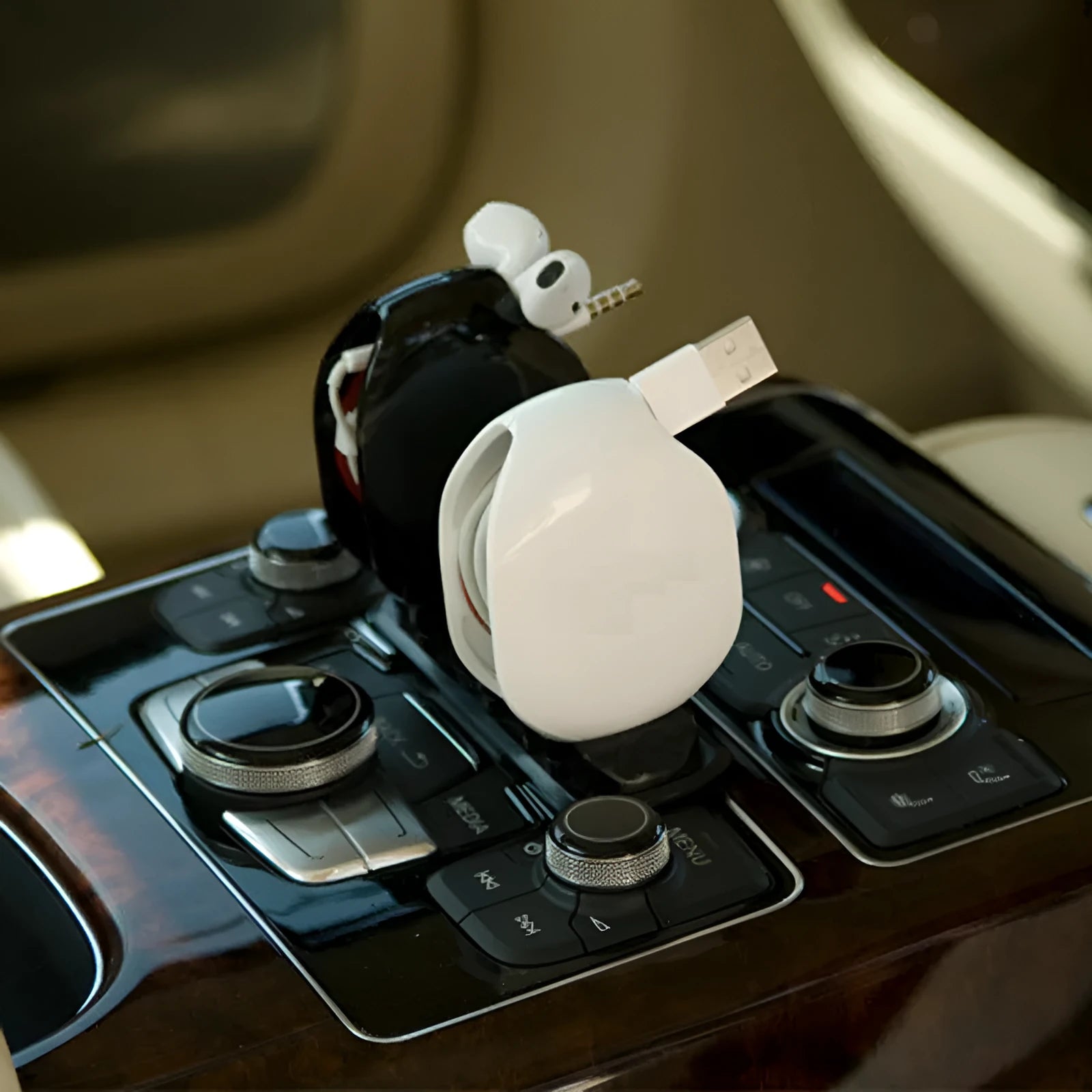 Automatic earphone cable winder retractor in assorted colours on a white background.