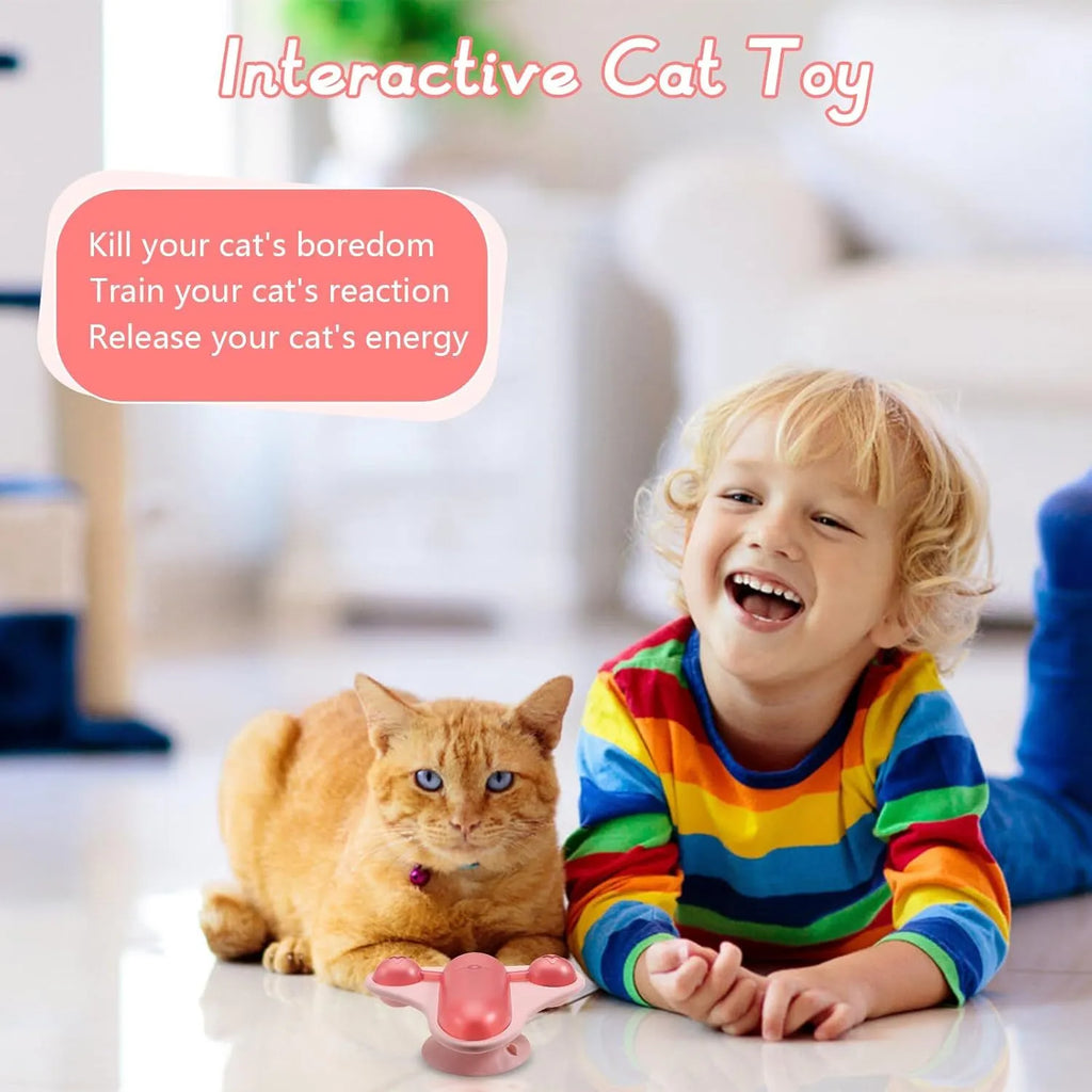 Blue interactive pet puzzle feeder toy with bell, catnip pouch, and central snack cabin on a floor.