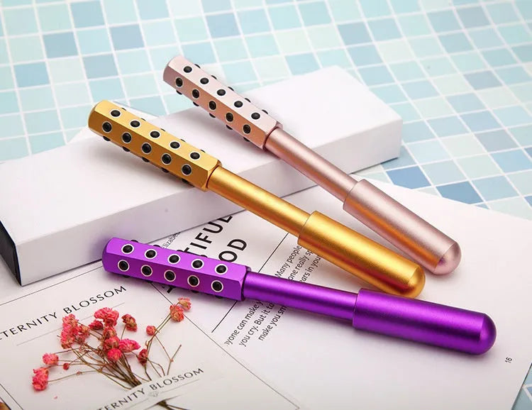 Germanium particles roller facial massager in purple colour with metal roller head