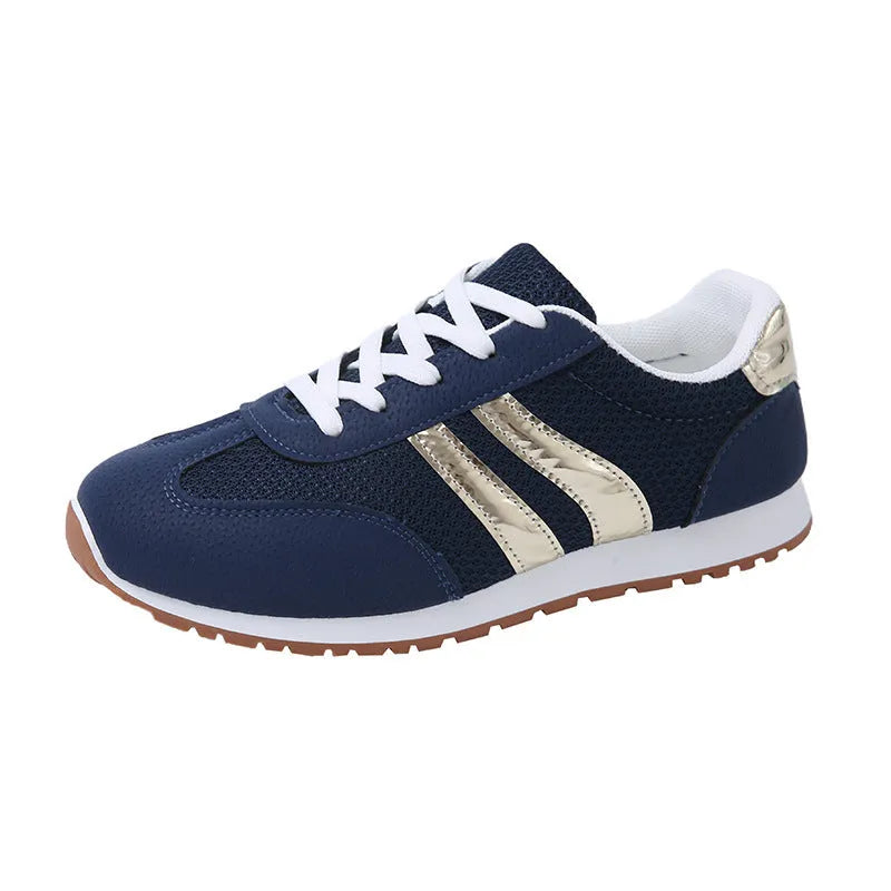 Blue women's casual tennis shoes with a cross shoulder strap and flat rubber sole on a white background.