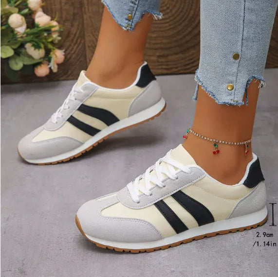 Blue and grey Cortez-style striped casual trainers with round toe and flat rubber sole.