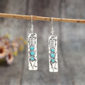 Silver geometric drop earrings with turquoise stone inlay on long strip design