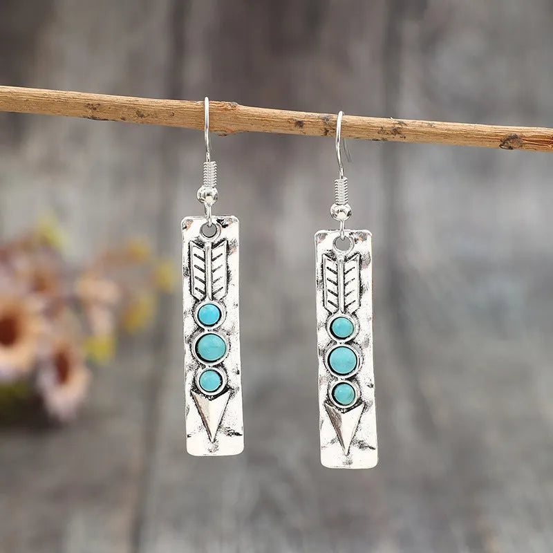Silver geometric drop earrings with turquoise stone inlay on long strip design