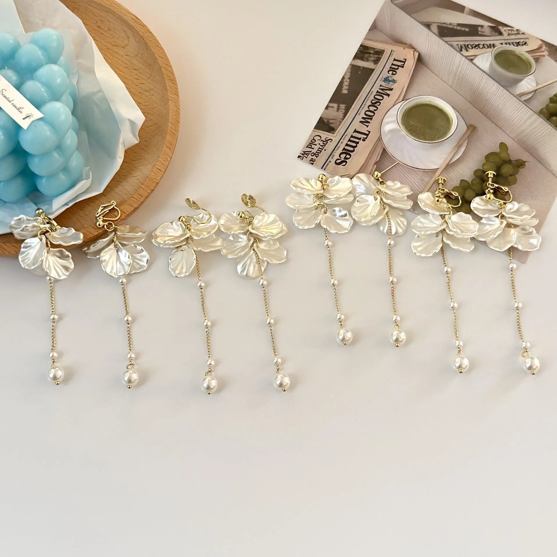 Women's acrylic shell pearl tassel earrings with 8.8cm drop length showing four ear clip style options