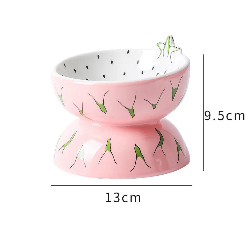 Orange patterned ceramic elevated cat bowl on a wooden floor.