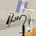 Black flexible phone tablet mount holder with suction base and bendy magnalium arm on a desk.