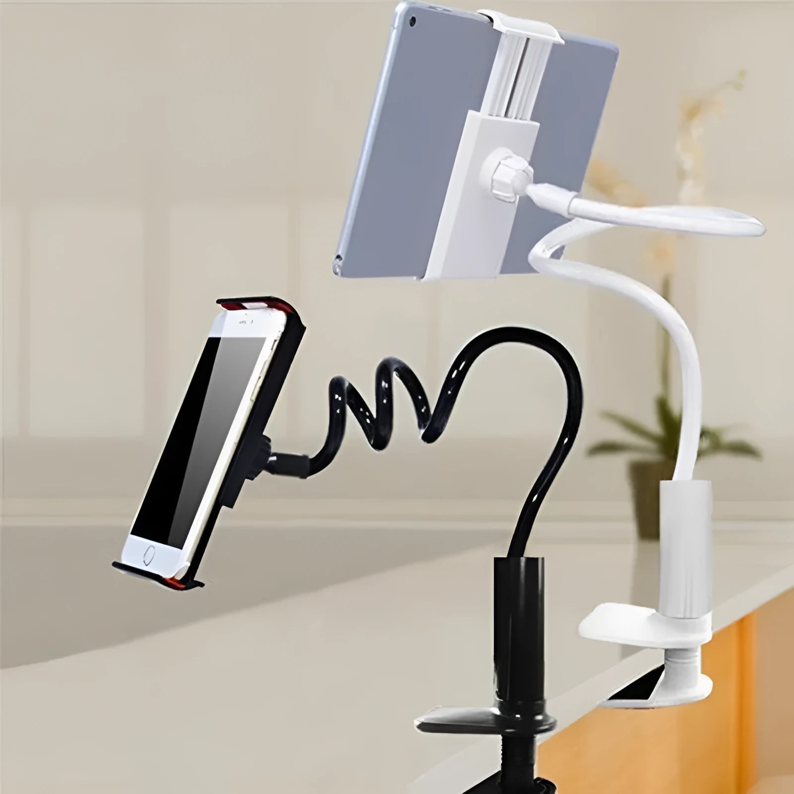 Black flexible phone tablet mount holder with suction base and bendy magnalium arm on a desk.