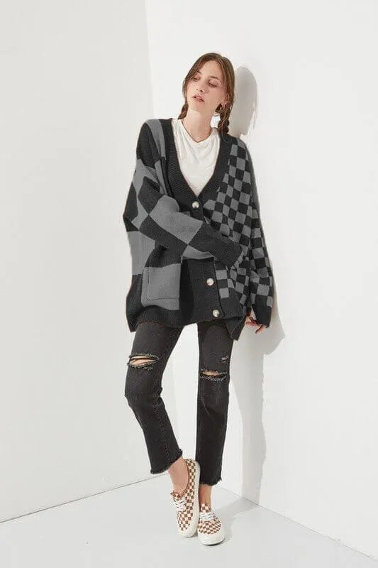Woman wearing a loose slim fit cardigan with a printed checks pattern in a colour selection.