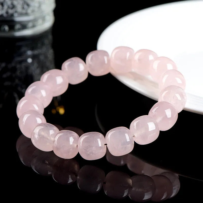Close-up of a pink crystal barrel bead bracelet with 11-12mm beads on a wrist.