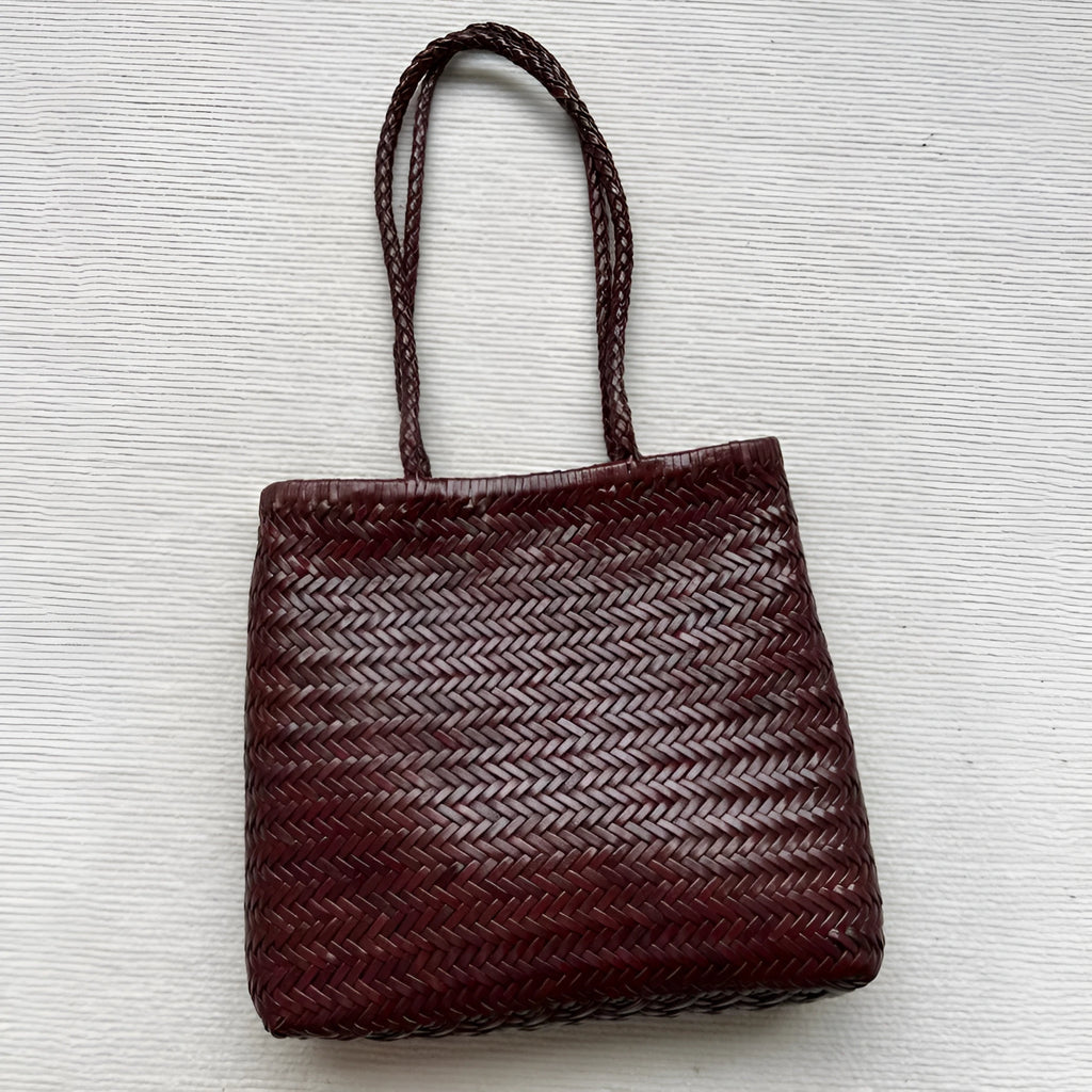 Handmade brown woven tote bag made from vintage top layer cowhide leather with a three-dimensional pocket.
