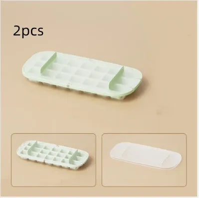 Ice cube tray with grid design and attached ice shovel stored in dedicated compartment