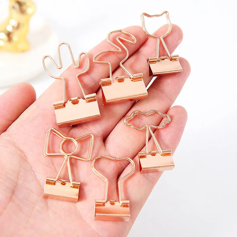 Gold metal paper clip with decorative charm attachment in flamingo design