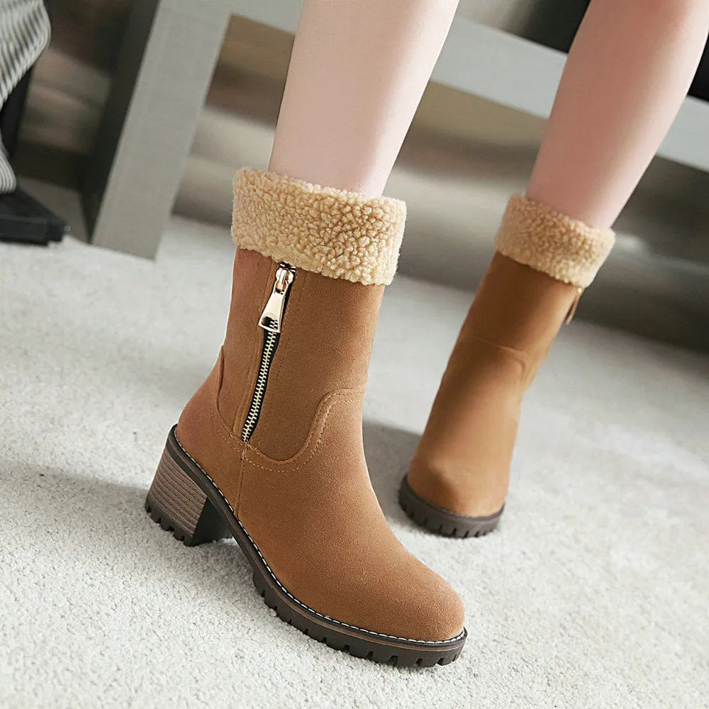 A pair of snow boots in black, shown with a soft plush lining and rubber insole.
