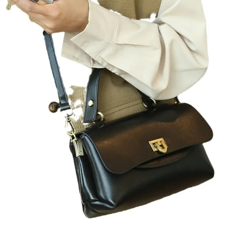 Women's brown leather saddle handbag with open outer pocket and double shoulder straps