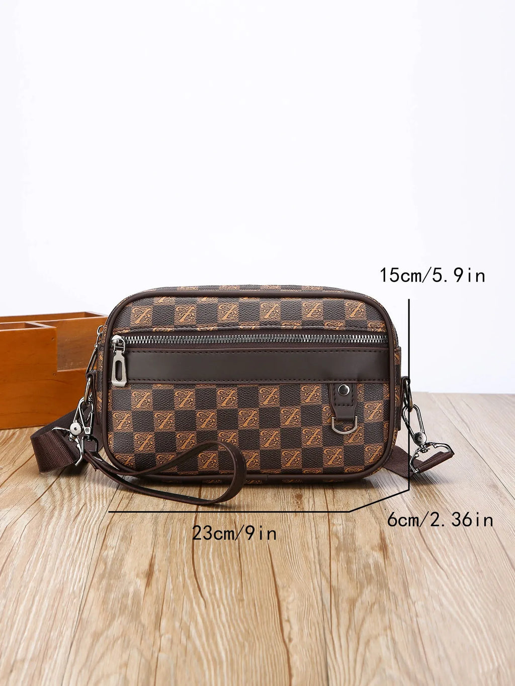 Men's black geometric pattern messenger bag shown in horizontal carrying position with shoulder strap