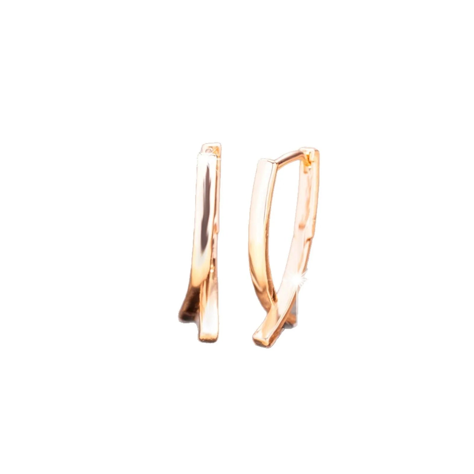 Rose gold cross shaped earrings with copper construction and light luxury aesthetic
