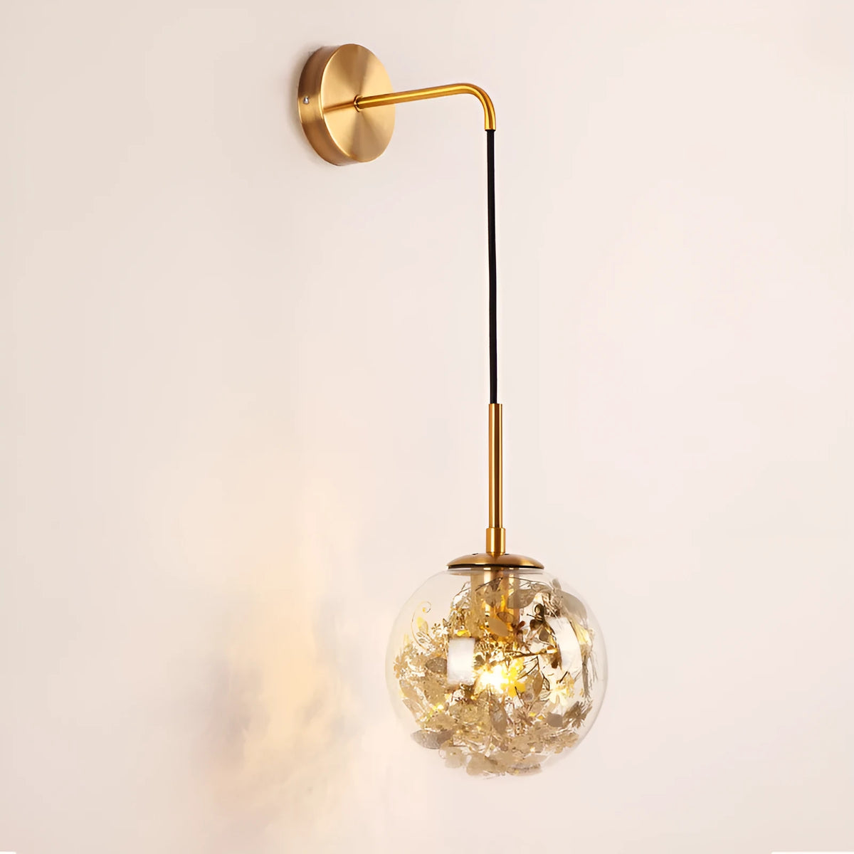 Small modern glass wall lamp in golden flower or silver flower finish for bedside lighting.