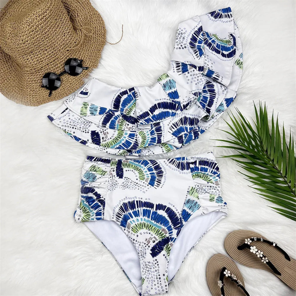 White women's one-shoulder swimsuit with large lotus leaf detail and split-leg design