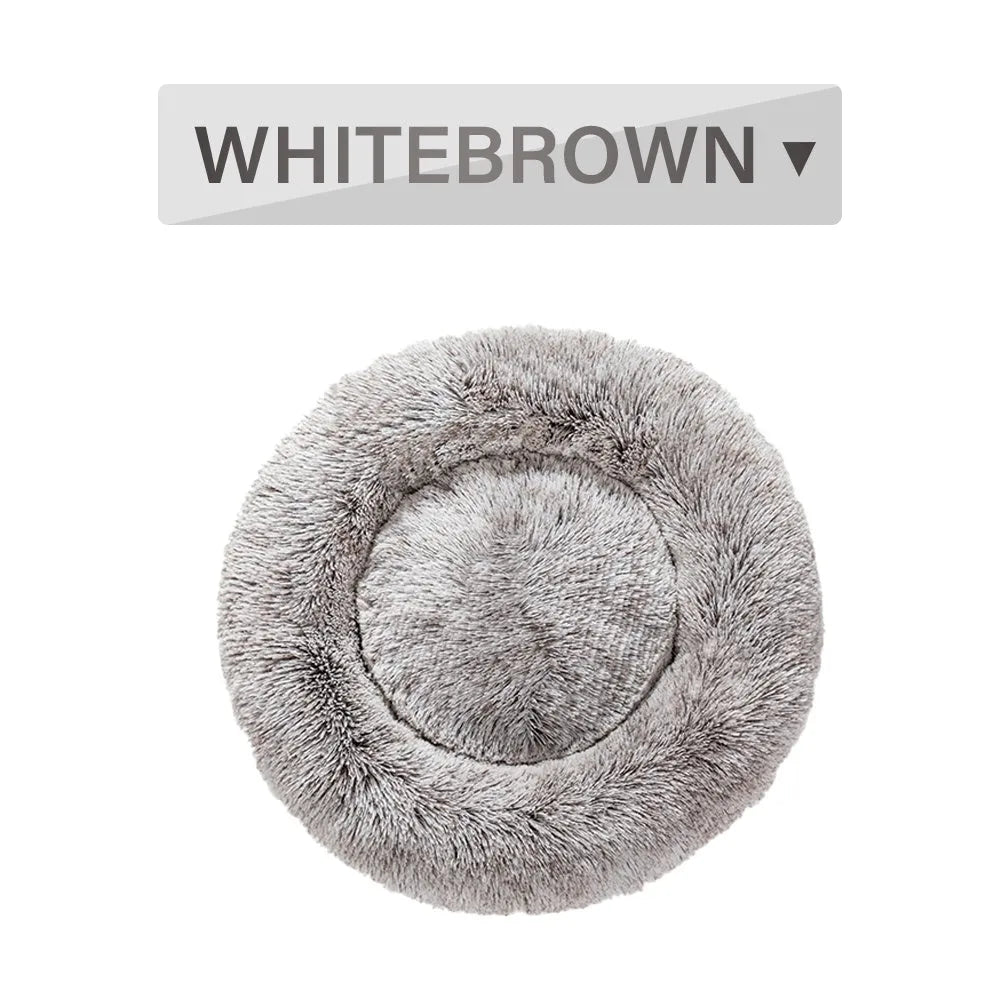 A round donut-shaped dog bed with a raised plush rim, shown in a light grey colour.