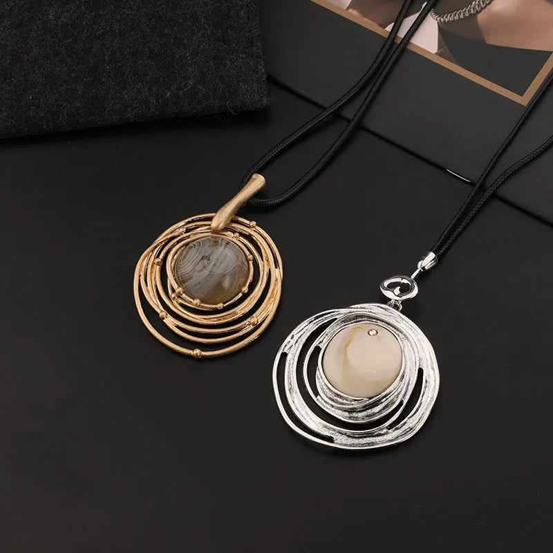 Gold geometric plaid pendant necklace with a textured snakeskin wax rope chain.