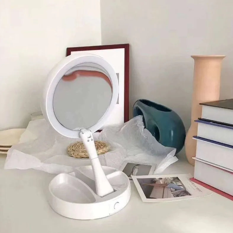 White foldable LED vanity mirror with storage tray and USB cable.
