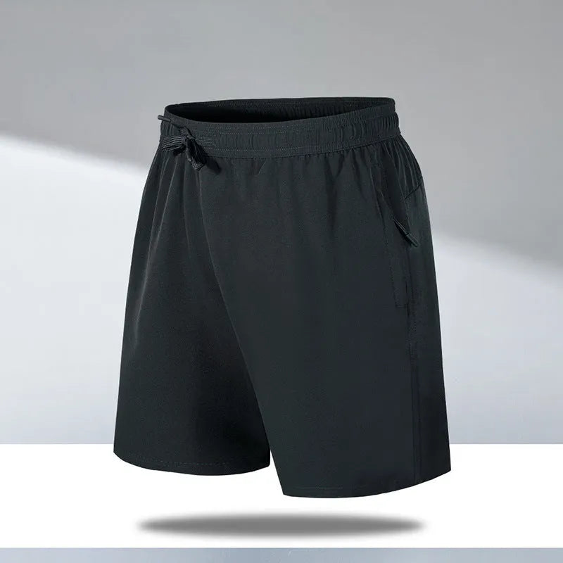 Man wearing loose black quick-dry sports shorts on a beach