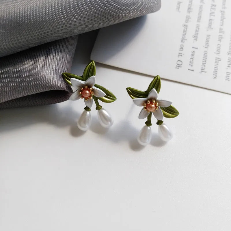 Women's alloy flower earrings with sterling silver needle contrasting colour detail, shown in clip-on and stud styles