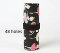 Canvas rolling pencil case with ballet girl print, showing multiple holes for pencils in a rolled-open state.