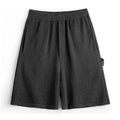 Cement grey straight leg sports shorts with an elastic waistband on a mannequin