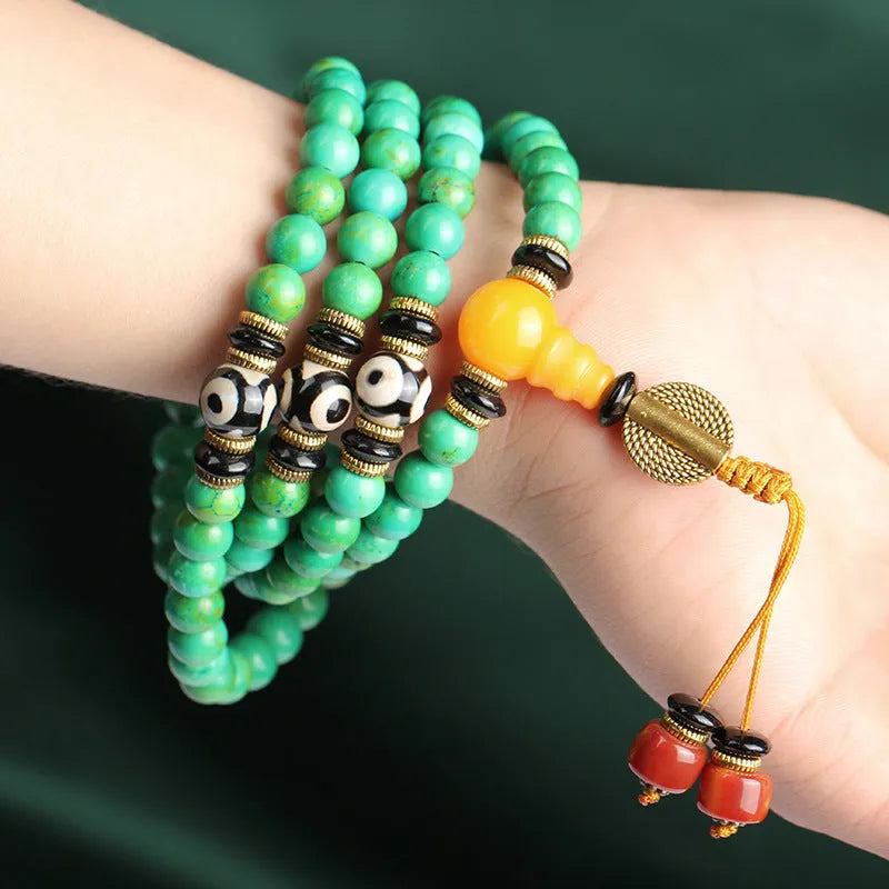 Natural turquoise bracelet with 108 round 8mm beads on wrist showing polished stone texture