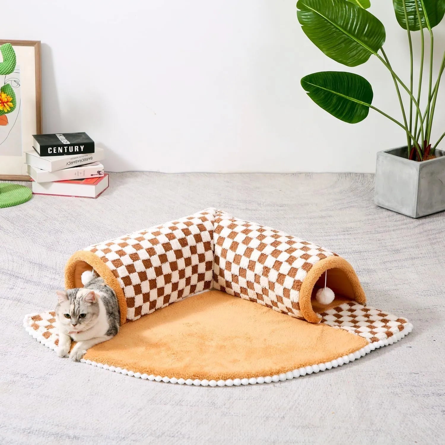 A plush fan-shaped dog and cat bed with an integrated tunnel, shown in a yellow plaid design.