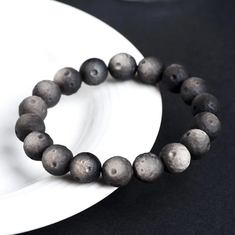 Obsidian crater ball bracelet with natural grinding texture in silver stone meteorite colour