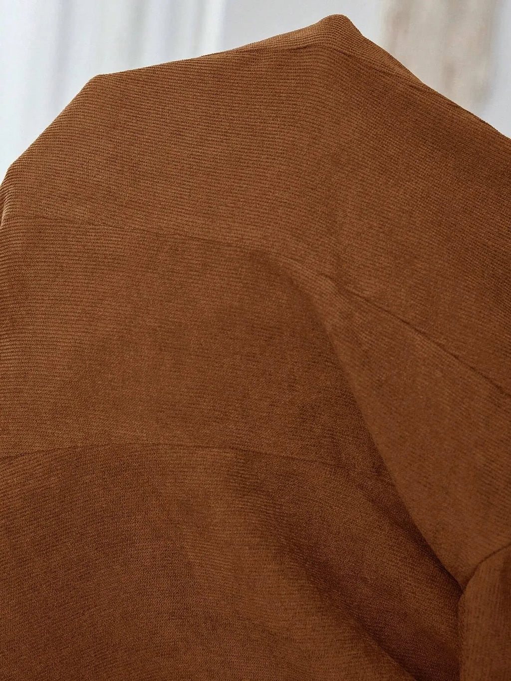 Brown men's single-breasted leisure suit coat with lapel and long sleeves.