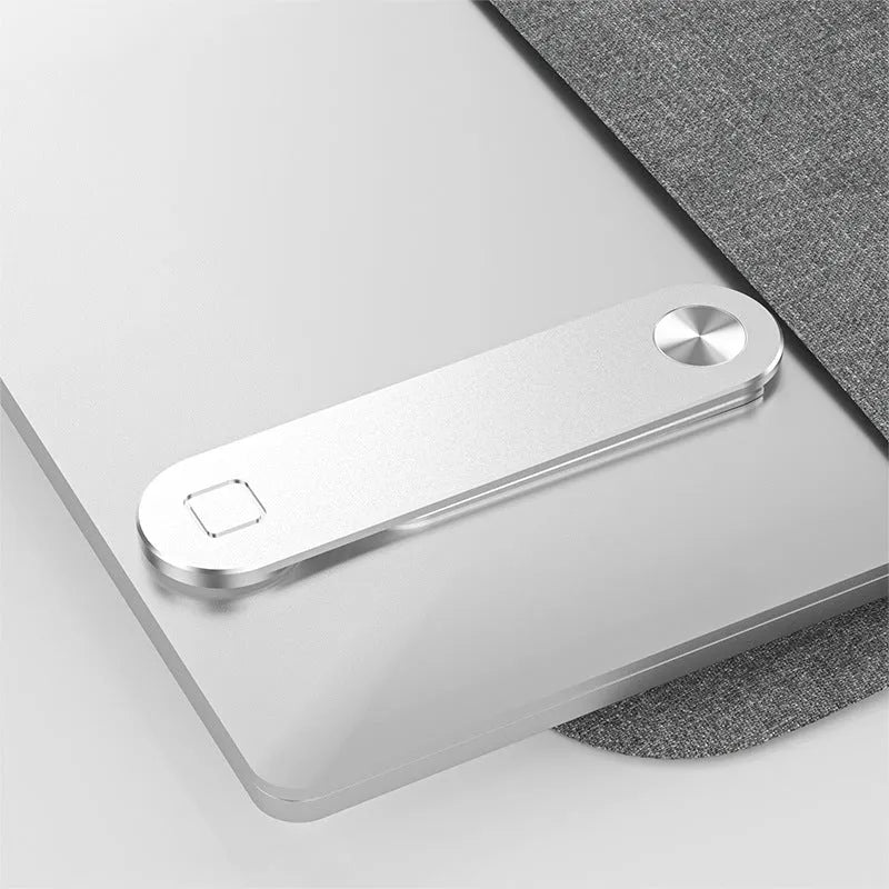 Black aluminium laptop phone holder with magnetic mount attached to laptop edge