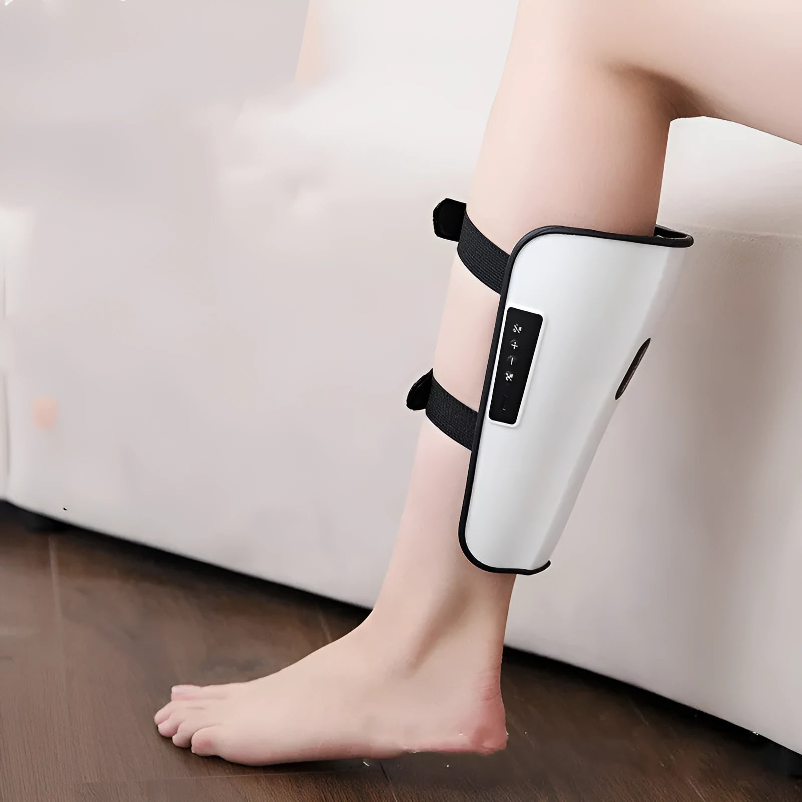 White plastic leg and calf massager unit with mechanical controls for acupoint massage and infrared heat therapy.