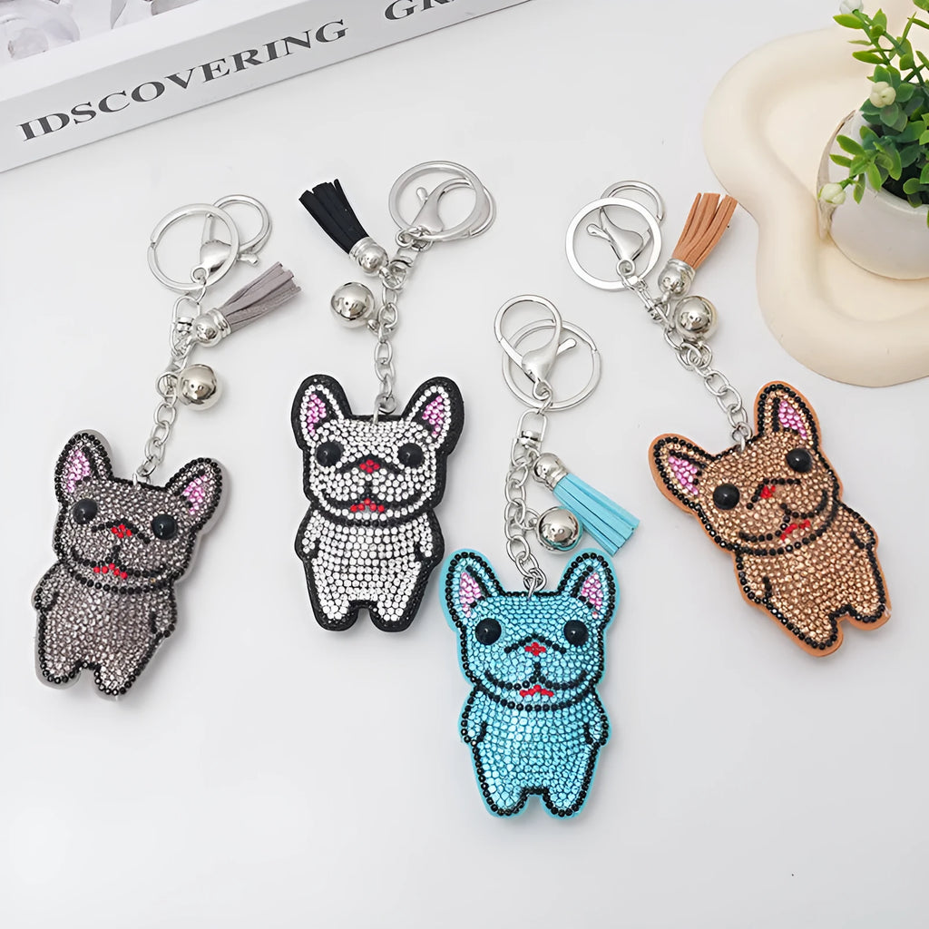 Close-up of a cartoon dog rhinestone keychain pendant on an alloy keyring