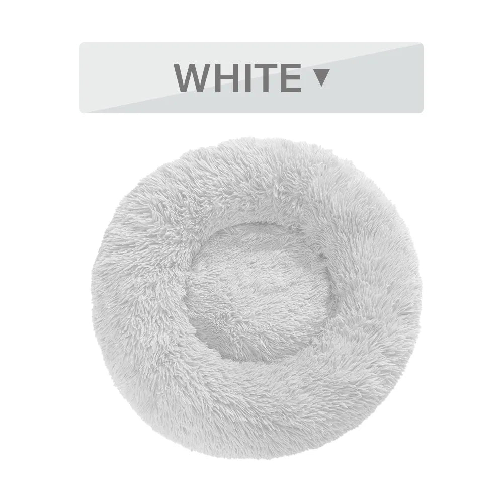 A round donut-shaped dog bed with a raised plush rim, shown in a light grey colour.