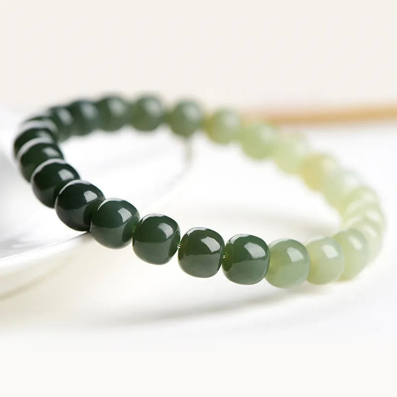 Natural Hetian jade bracelet showing water gradient colour on polished beads