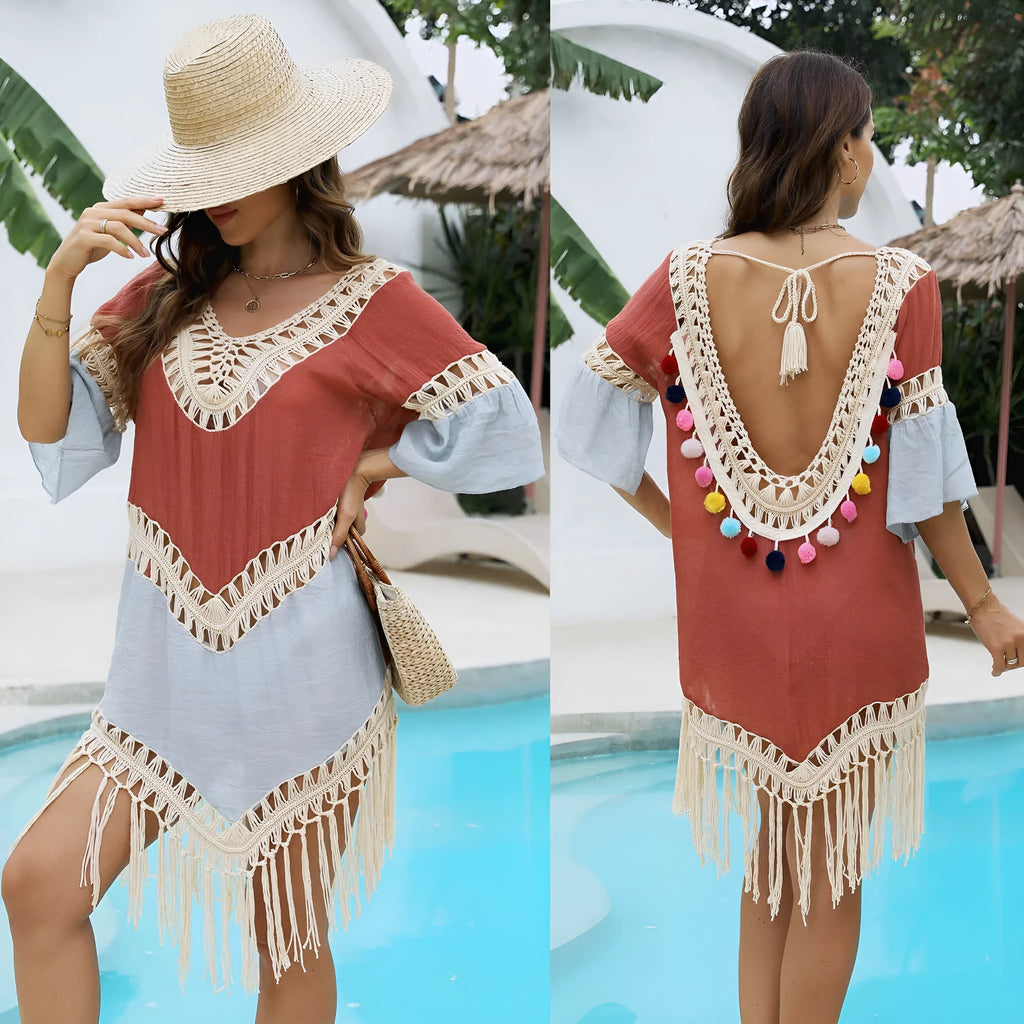 Orange floral beach overskirt with hand crochet detail and tassels, laid flat.