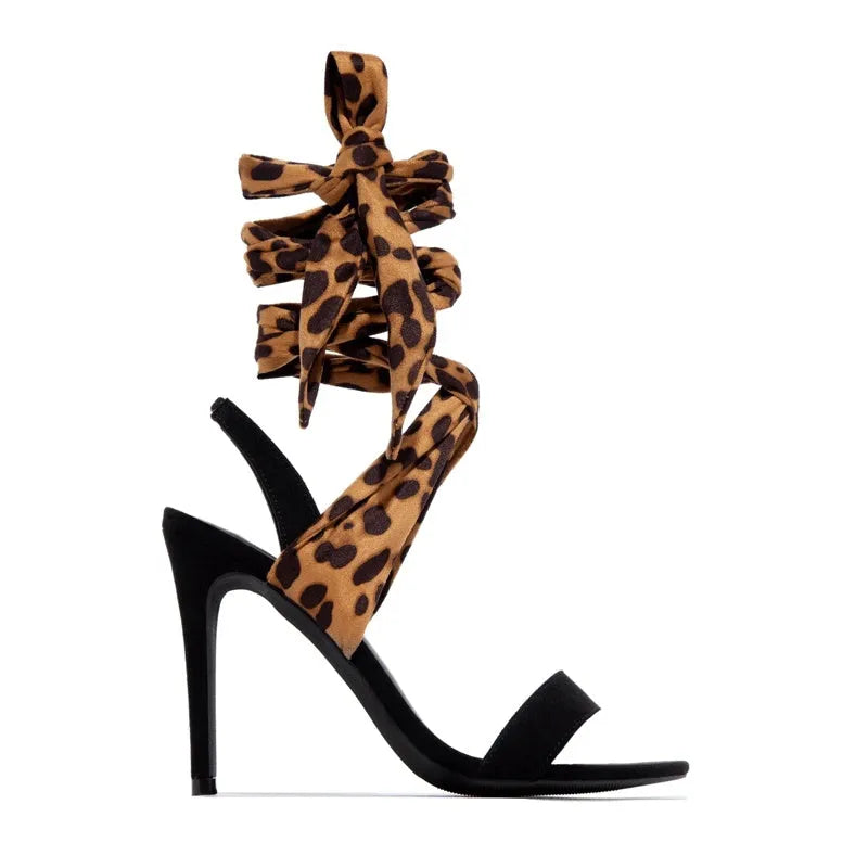 Light brown leopard print high heel shoes with cross strap design and stiletto heel