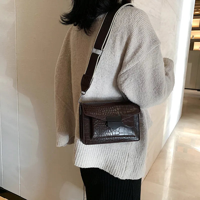 Vintage PU leather crossbody bag in black, shown with adjustable strap.