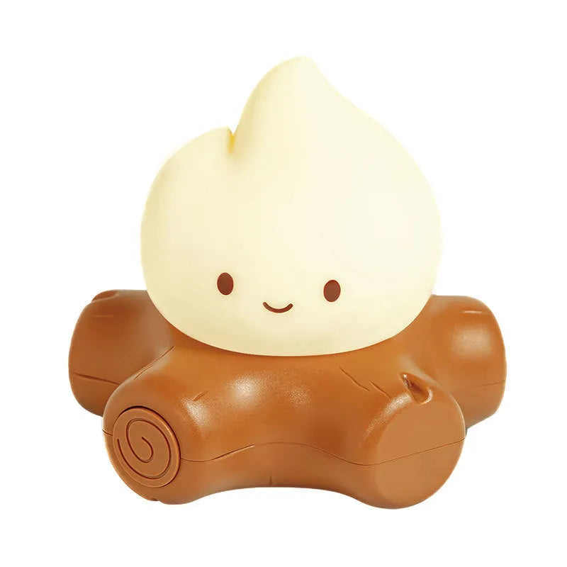 Silicone small fire pile cartoon night light on a surface, showing its yellow glow and compact size.