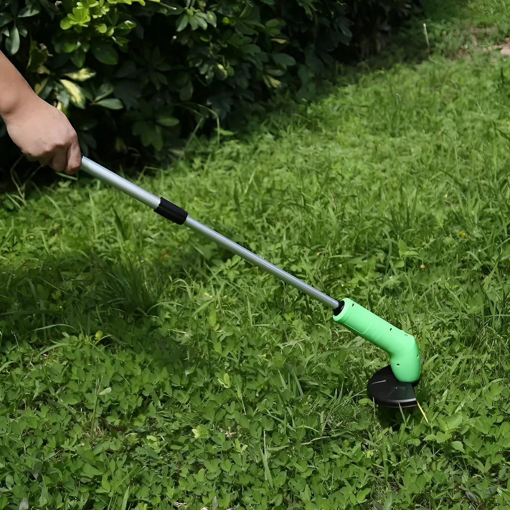 Cordless Zip Trim lawn trimmer with extension pole and protective shield on garden grass