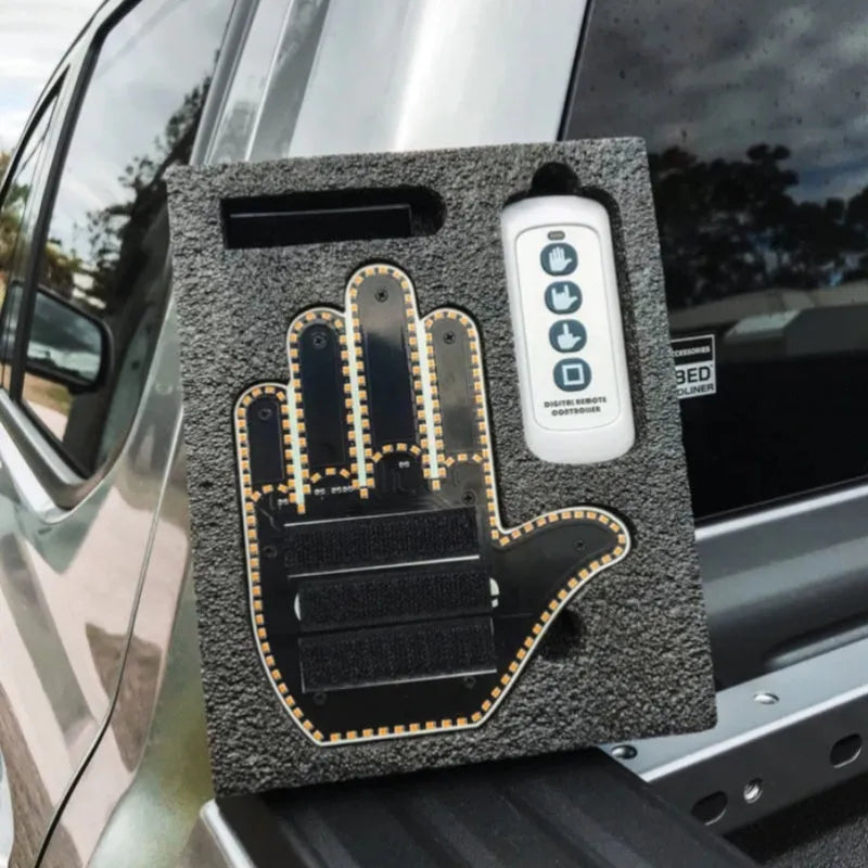 Black plastic LED gesture light for cars showing middle finger symbol with remote control