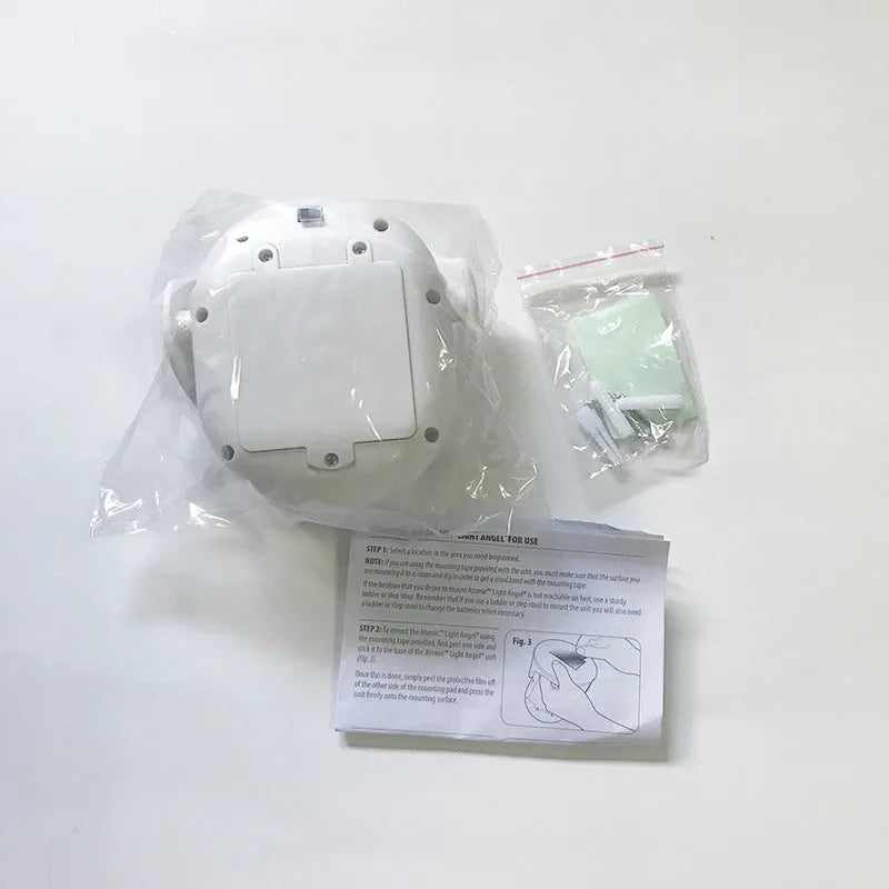 White Atomic Angel induction lamp with dimensions 13.3cm wide by 9.8cm deep by 15.8cm tall