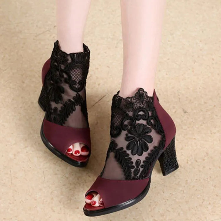Black women's gladiator sandals with floral lace upper, square high heel, peep toe, and zip closure.